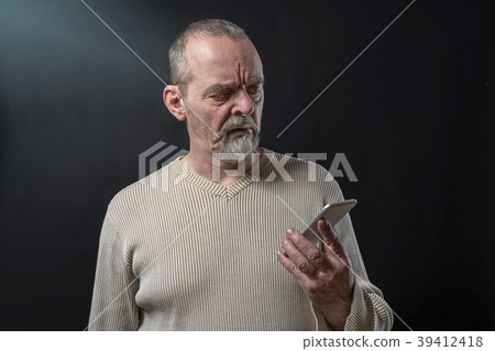 old man does not understand his smart phone 39412418