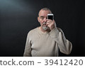 old man does not understand his smart phone 39412420