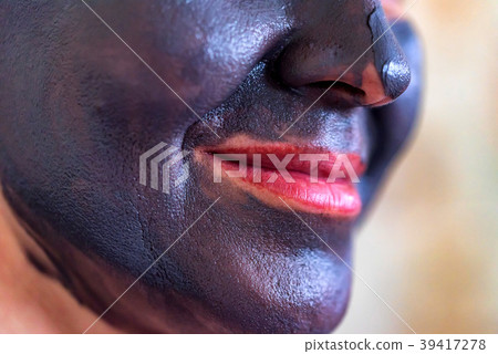 Face of woman covered in clay mask 39417278