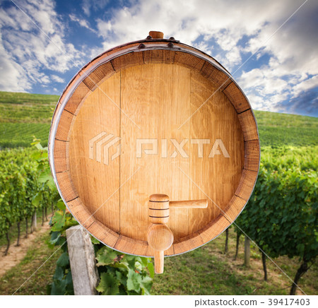 Wine barrel over vineyard Wine barrel over vineyard 39417403