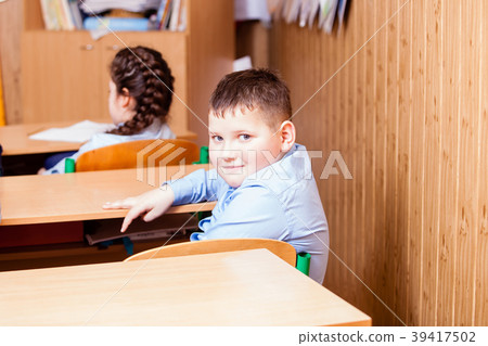cute boy is sitting on the lesson 39417502
