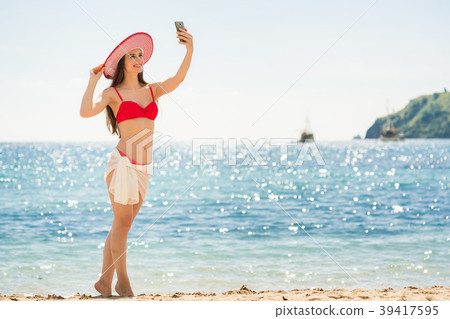 Beautiful young woman wearing a trendy striped hat Beautiful young woman wearing a trendy striped hat 39417595