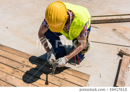 High-angle view of a blue-collar worker using a 39417618