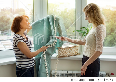 Interior designer shows samples of fabrics and 39417965