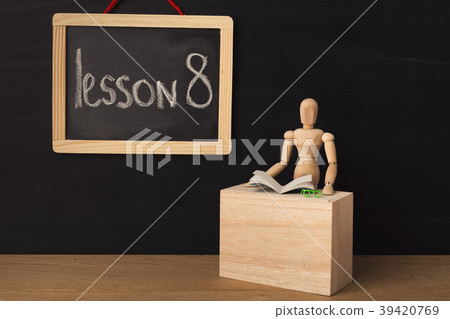 Wooden mannequin and chalkboard over black Wooden mannequin and chalkboard over black 39420769