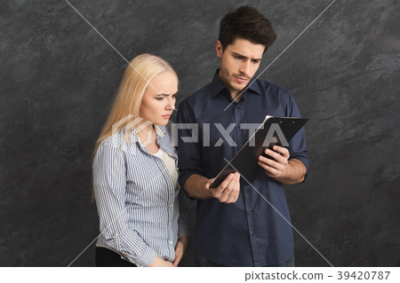Serious couplereading paper on gray background 39420787