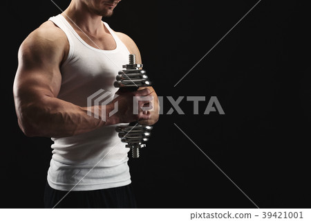 Strong athletic man with dumbbell showes muscular Strong athletic man with dumbbell showes muscular 39421001