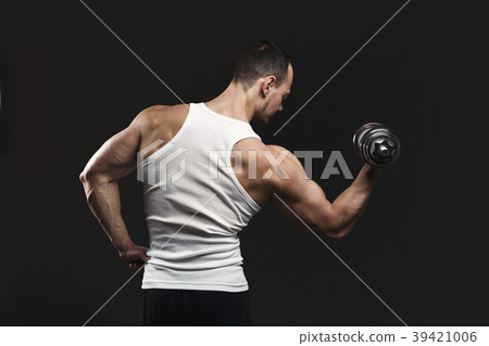 Strong athletic man with dumbbell showes muscular Strong athletic man with dumbbell showes muscular 39421006