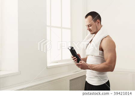 Male bodybuilder drinking water after workout Male bodybuilder drinking water after workout 39421014