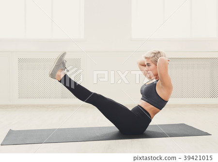 Woman training yoga in boat pose. Woman training yoga in boat pose. 39421015