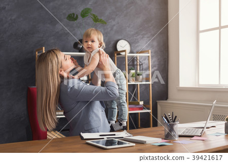 Young working mother spending time with baby 39421617