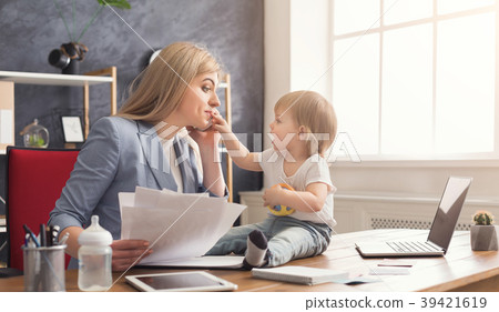 Young mother working and spending time with baby 39421619