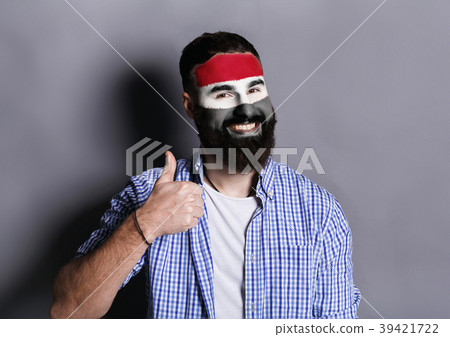 Young man with Egypt flag painted on his face Young man with Egypt flag painted on his face 39421722