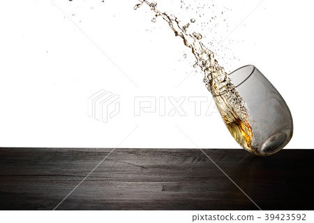 Whiskey jumping out of a glass 39423592