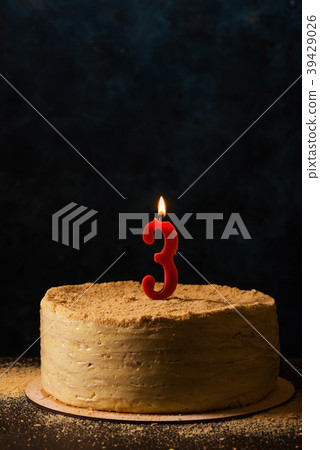 Traditional napoleon cake with three-shaped candle 39429026