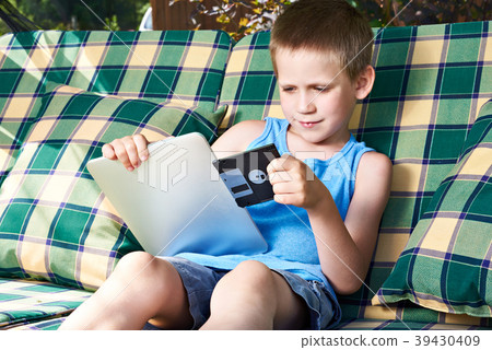 Little boy with floppy disk and tablet pc 39430409