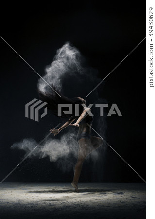 Brunette jumping gracefully in dust cloud view 39430629