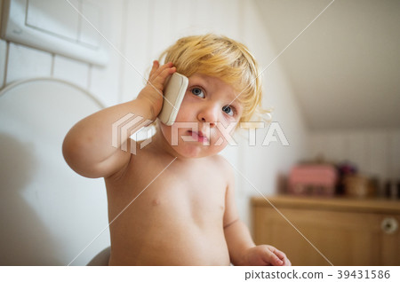Cute toddler boy with smartphone in the bathroom. Cute toddler boy with smartphone in the bathroom. 39431586