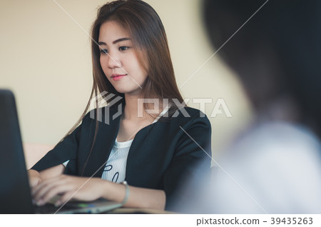 Young Asian secretary female working with laptop 39435263