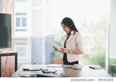 Asian executive female managing papework Asian executive female managing papework 39435269