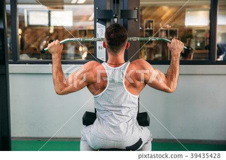 A young athlete trains in the gym. Shows the A young athlete trains in the gym. Shows the 39435428