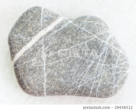 pebble of Greywacke sandstone on white marble 39436512