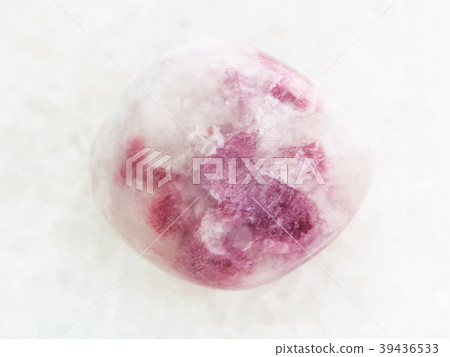 polished pink Sodalite gemstone on white marble polished pink Sodalite gemstone on white marble 39436533