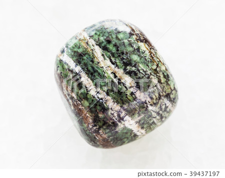 polished chrysotile gemstone on white marble polished chrysotile gemstone on white marble 39437197
