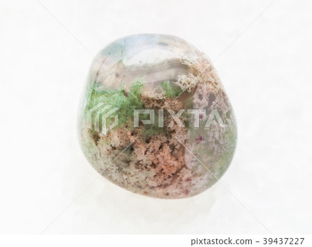 polished Moss Agate gemstone on white marble 39437227