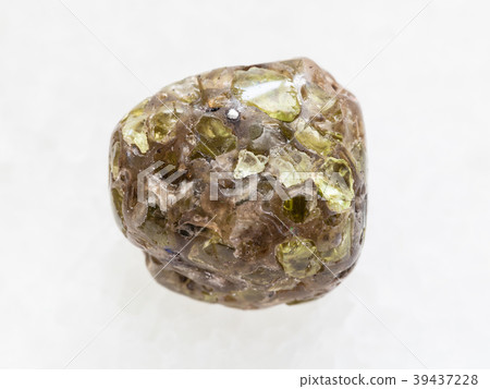 polished Peridot gemstone on dark white marble polished Peridot gemstone on dark white marble 39437228