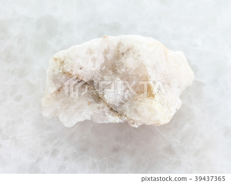 scheelite (tungsten ore) in rough stone on white scheelite (tungsten ore) in rough stone on white 39437365