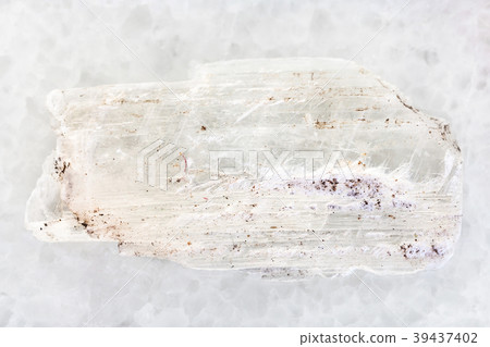 raw crystal of Gypsum gemstone on white marble raw crystal of Gypsum gemstone on white marble 39437402