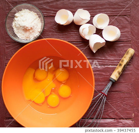 Ingredients for baking - broken eggs, flour. 39437455
