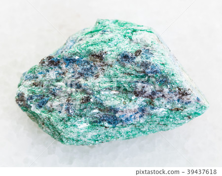 rough Fuchsite (chrome mica) stone on white marble 39437618