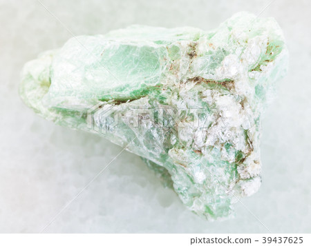 rough green talc stone on white marble 39437625