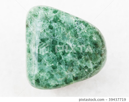 tumbled green Jadeite gemstone on white marble tumbled green Jadeite gemstone on white marble 39437719