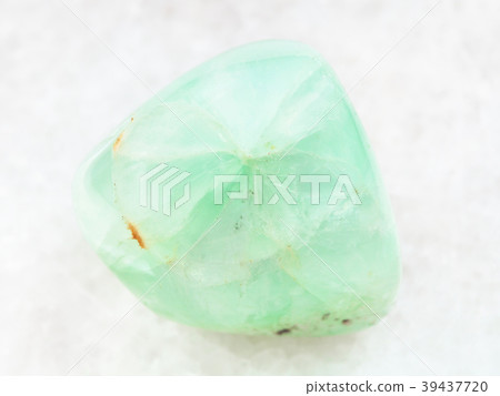 tumbled Prehnite gemstone on white marble 39437720