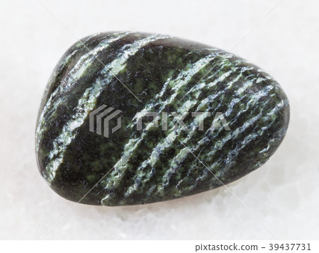 tumbled Chrysotile asbestos gemstone on white tumbled Chrysotile asbestos gemstone on white 39437731