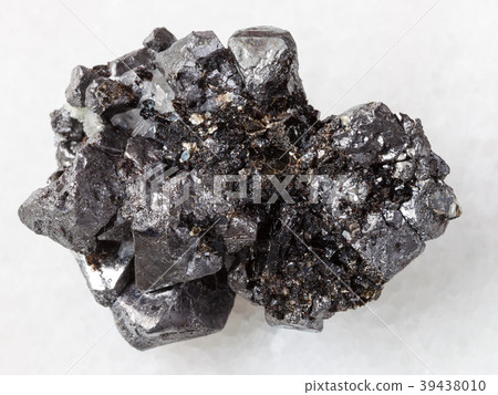 rough crystalline Magnetite stone on white marble 39438010