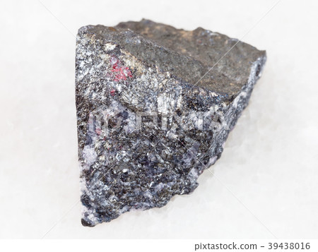 rough antimonite stone on white marble 39438016