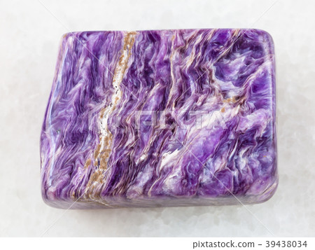 polished slab of charoite gemstone on white marble 39438034