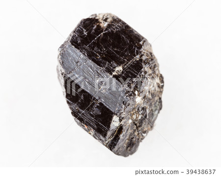 raw crystal of Schorl (black tourmaline) on white raw crystal of Schorl (black tourmaline) on white 39438637