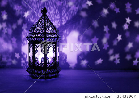 Ornamental Arabic lantern with burning candle Ornamental Arabic lantern with burning candle 39438907