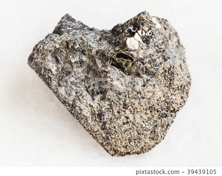 rough peridotite stone with phlogopite on white 39439105