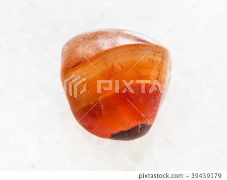 polished carnelian gem stone on white marble 39439179