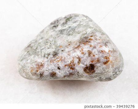 chondrodite in tumbled calcite stone on white 39439276