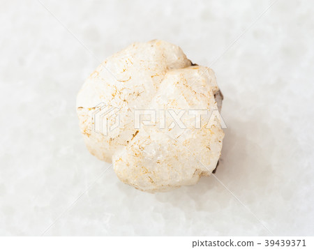 rough analcime gemstone on white 39439371