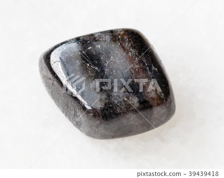 pebble of anthophyllite gemstone on white 39439418