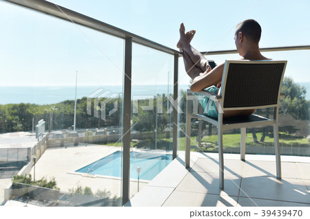 young man sun tanning in a chair 39439470