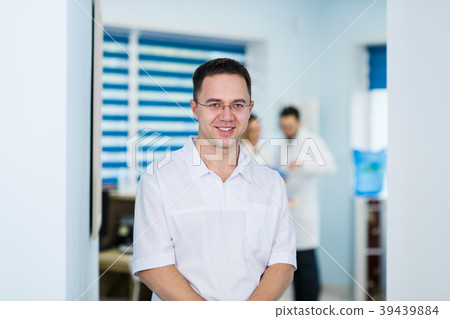 Portrait of friendly male doctor smiling Portrait of friendly male doctor smiling 39439884
